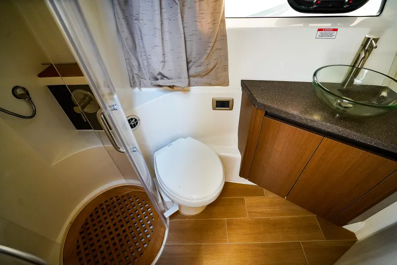 Slide: The Image of Luxurious bathroom in 2016 Sea Ray 400 Fly yacht with modern fixtures and wooden accents. - 43