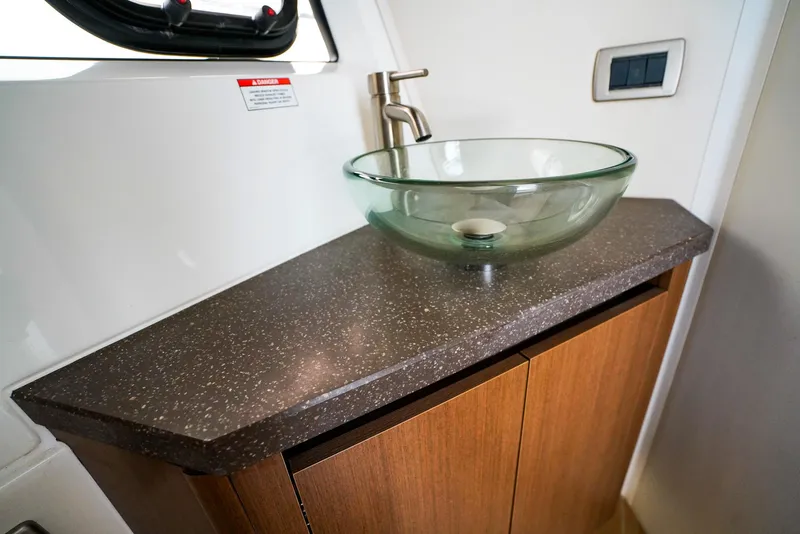Slide: The Image of Glass sink on wooden cabinet in 2016 Sea Ray 400 Fly yacht bathroom. - 44