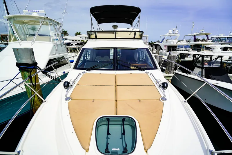 Slide: The Image of 2016 Sea Ray 400 Fly yacht docked at marina, featuring spacious deck and sleek design. - 8