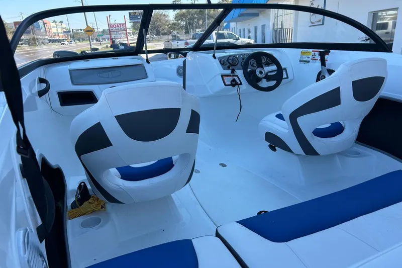Slide: The Image of Interior of a 2021 Tahoe 450 TF boat with white and blue seating. - 6