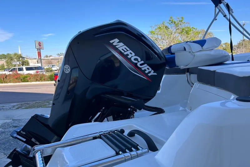 Slide: The Image of Tahoe 450 TF boat with Mercury outboard motor, 2021 model, parked outdoors. - 8