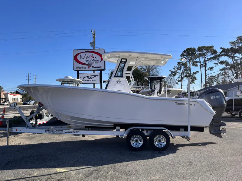 Slide: The Image of 2025 Tidewater 232 CC Adventure boat on trailer, displayed outdoors at a dealership. - 0