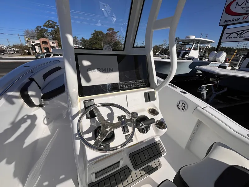 Slide: The Image of 2025 Tidewater 232 CC Adventure boat console with Garmin display and steering wheel. - 10