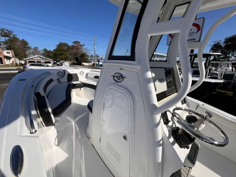 Slide: The Image of 2025 Tidewater 232 CC Adventure boat interior with modern console and seating. - 11
