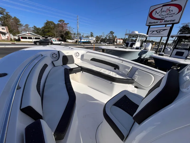 Slide: The Image of 2025 Tidewater 232 CC Adventure boat with spacious seating, displayed at a marina. - 12