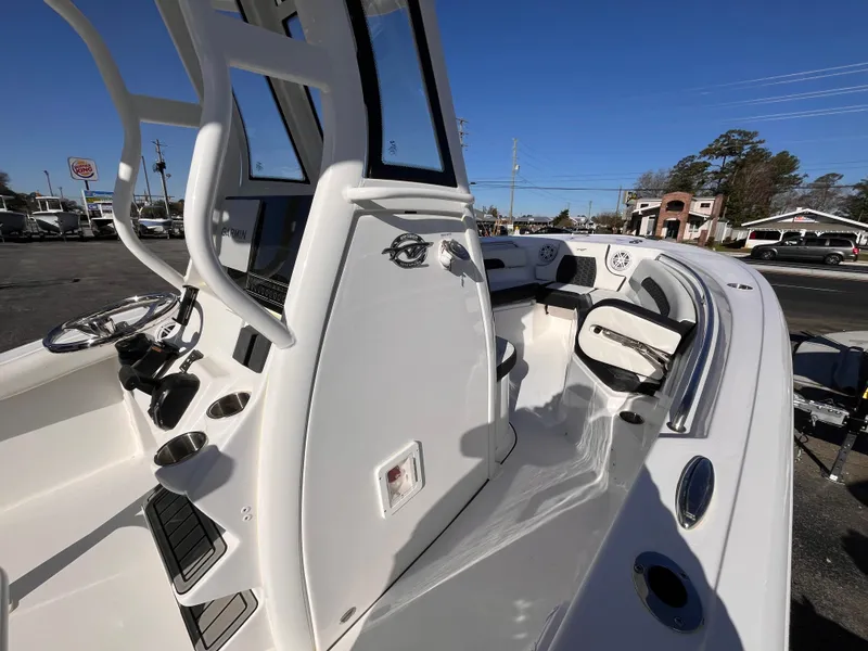 Slide: The Image of 2025 Tidewater 232 CC Adventure boat interior with modern console and seating. - 15