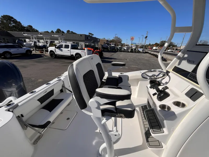 Slide: The Image of 2025 Tidewater 232 CC Adventure boat interior with seating and steering console. - 16