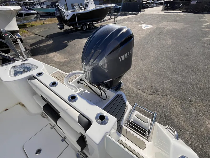 Slide: The Image of 2025 Tidewater 232 CC Adventure boat with Yamaha outboard motor, docked in a marina. - 5