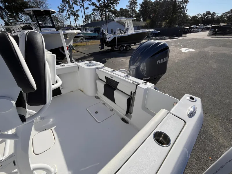 Slide: The Image of 2025 Tidewater 232 CC Adventure boat with Yamaha engine, parked outdoors. - 6