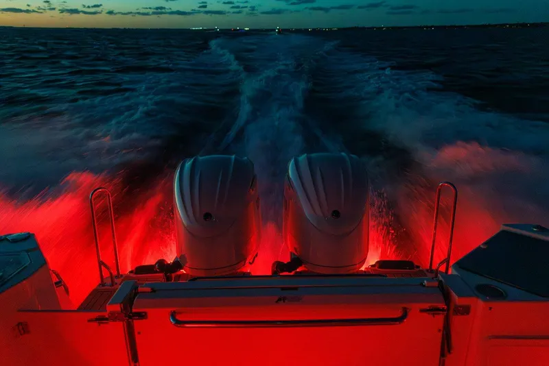 Slide: The Image of 2026 Solara S 310 Sport Coupe with illuminated engines cruising at dusk. - 16