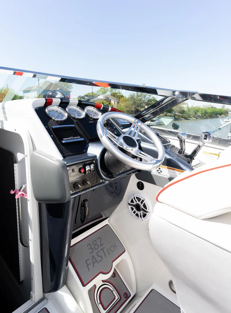 Slide: The Image of 2017 Formula 382 FASTech boat cockpit with steering wheel and control panel. - 13
