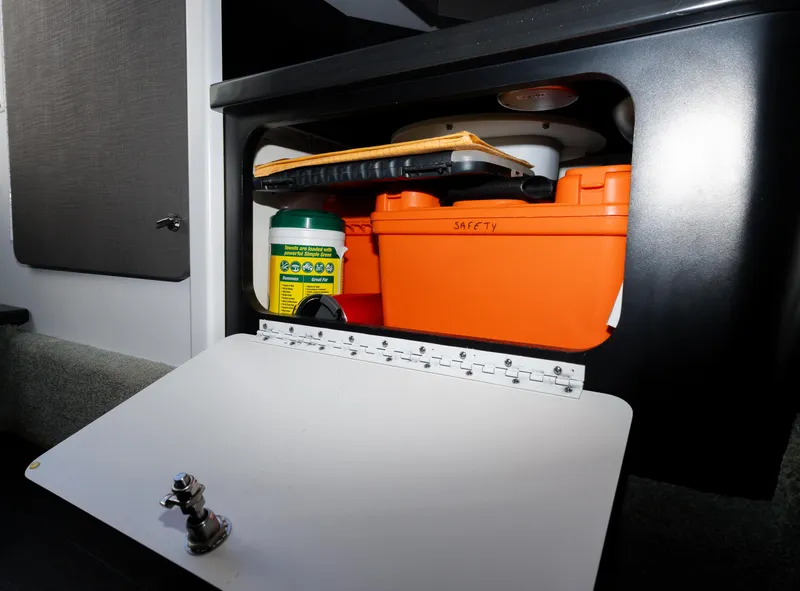 Slide: The Image of Storage compartment in a 2017 Formula 382 FASTech boat, containing safety equipment and supplies. - 23