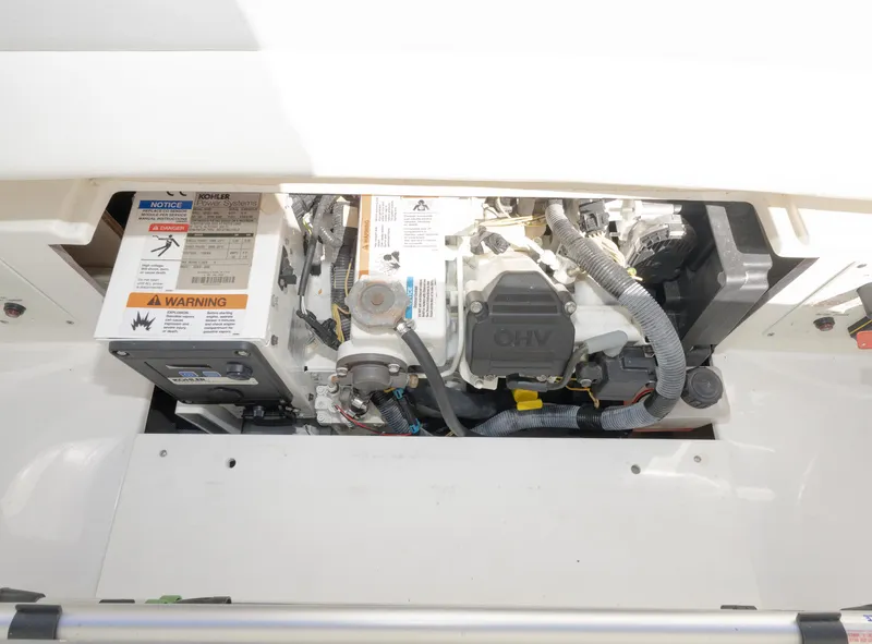 Slide: The Image of Engine compartment of a 2017 Formula 382 FASTech boat, showcasing mechanical components and warning labels. - 33