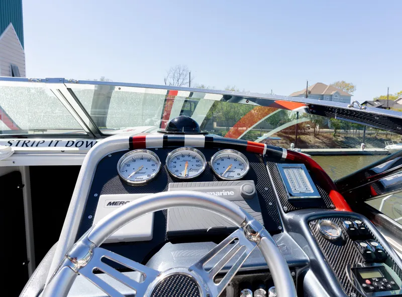 Slide: The Image of 2017 Formula 382 FASTech boat dashboard with gauges and steering wheel. - 5