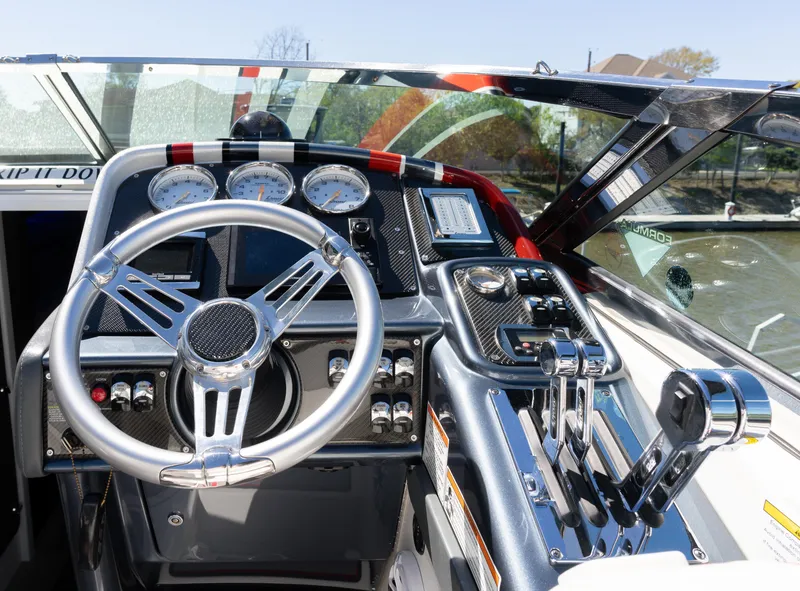 Slide: The Image of 2017 Formula 382 FASTech boat cockpit with steering wheel and control panel. - 8