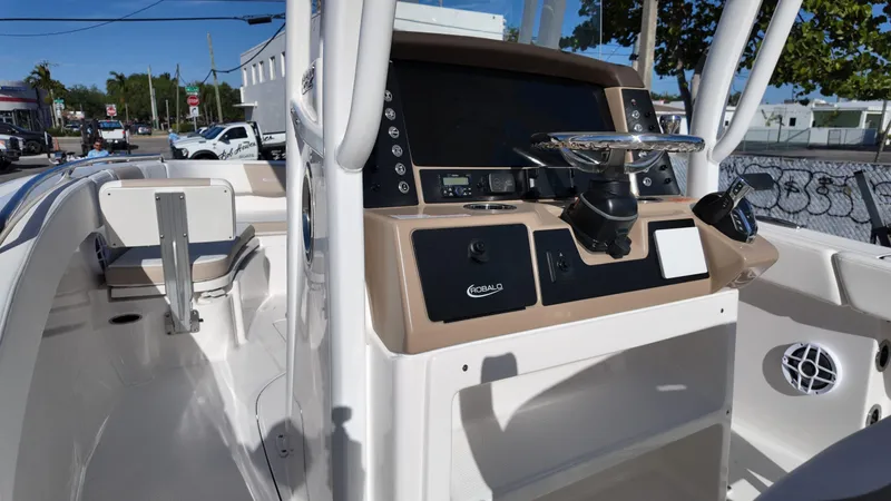 Slide: The Image of 2025 Robalo 232 Explorer boat cockpit with modern controls and seating. - 5