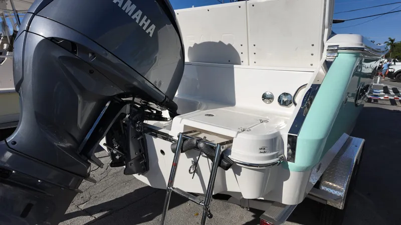 Slide: The Image of 2025 Robalo 232 Explorer boat with Yamaha outboard motor, rear view. - 9