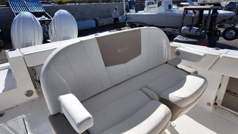 Slide: The Image of 2025 Robalo R250 boat seating with dual outboard motors in the background. - 13