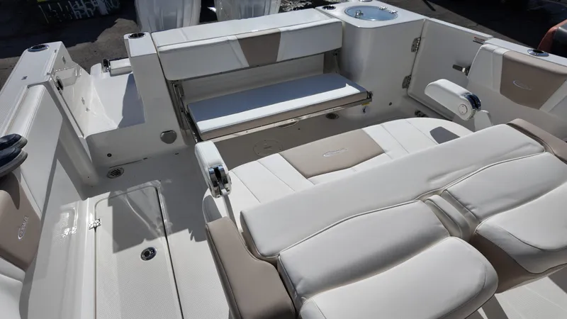 Slide: The Image of 2025 Robalo R250 boat interior with beige and white seating, showcasing luxury and comfort. - 15