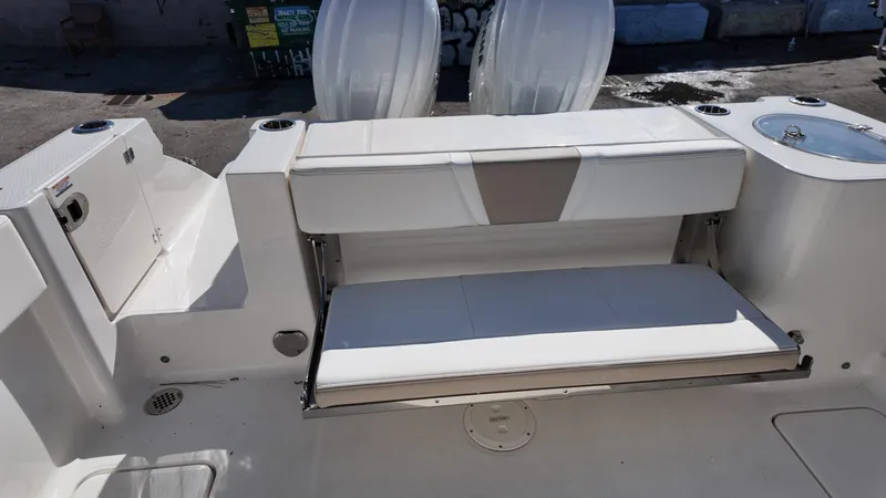 Slide: The Image of 2025 Robalo R250 boat interior with foldable seating and storage compartments. - 18