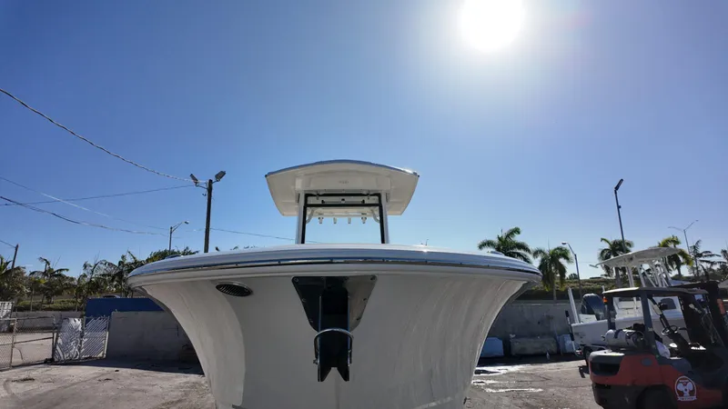 Slide: The Image of 2025 Robalo R250 boat under clear blue sky in a sunny marina. - 3