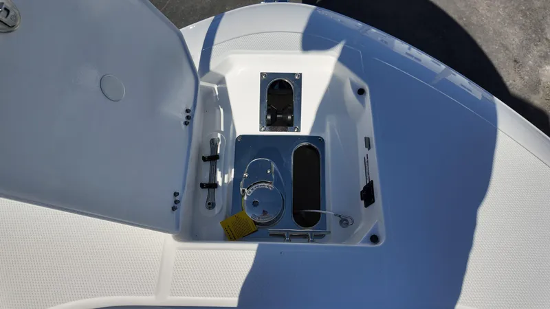 Slide: The Image of 2025 Robalo R250 boat anchor compartment with open hatch and winch system. - 5