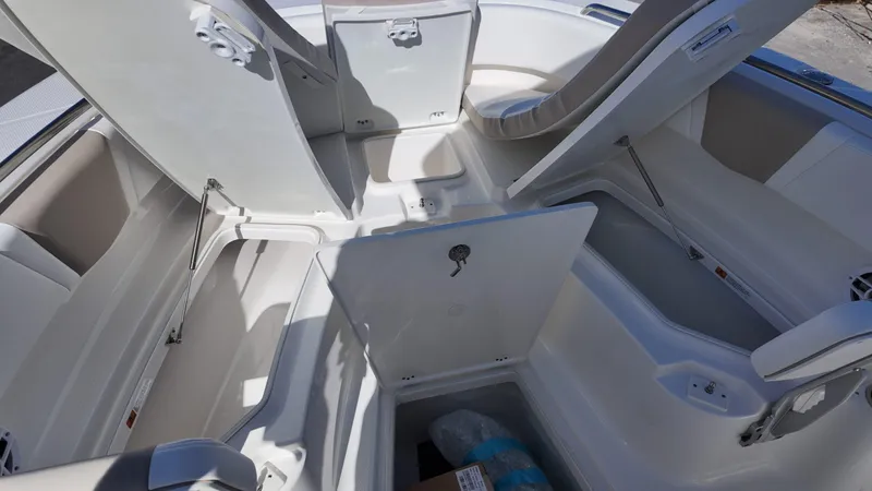 Slide: The Image of 2025 Robalo R250 boat interior with open storage compartments and seating. - 6