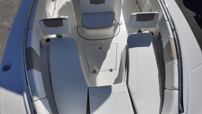 Slide: The Image of 2025 Robalo R250 boat interior with white seating and storage compartments. - 9