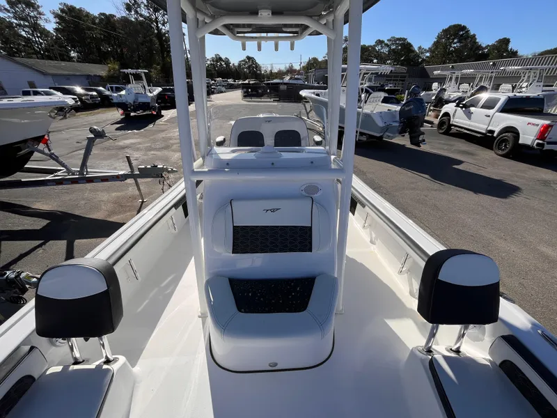 Slide: The Image of 2025 Tidewater 2300 Carolina Bay boat, center console view, parked in a marina. - 11