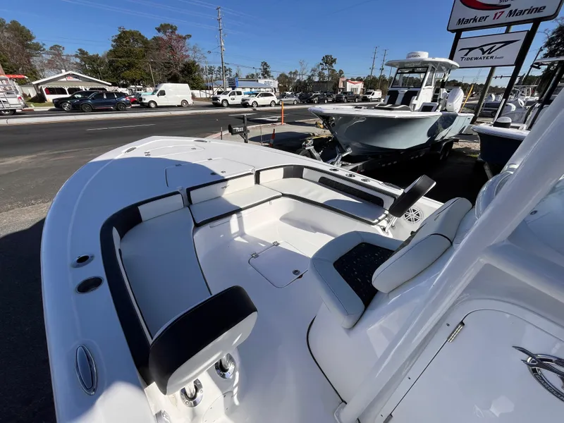 Slide: The Image of 2025 Tidewater 2300 Carolina Bay boat with seating, displayed at a marine dealership. - 12