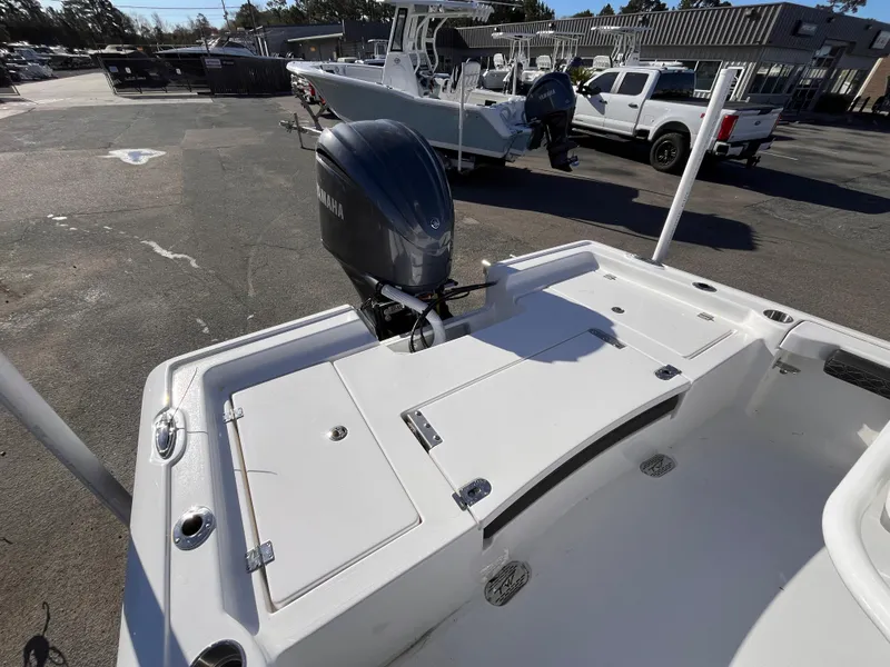 Slide: The Image of 2025 Tidewater 2300 Carolina Bay boat with outboard motor in a parking lot. - 5