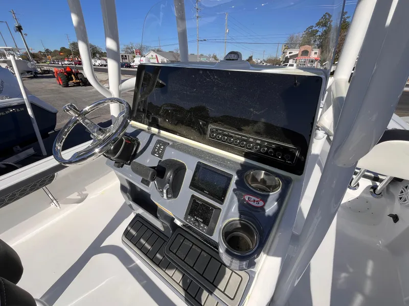 Slide: The Image of 2025 Tidewater 2300 Carolina Bay boat console with steering wheel and control panel. - 8