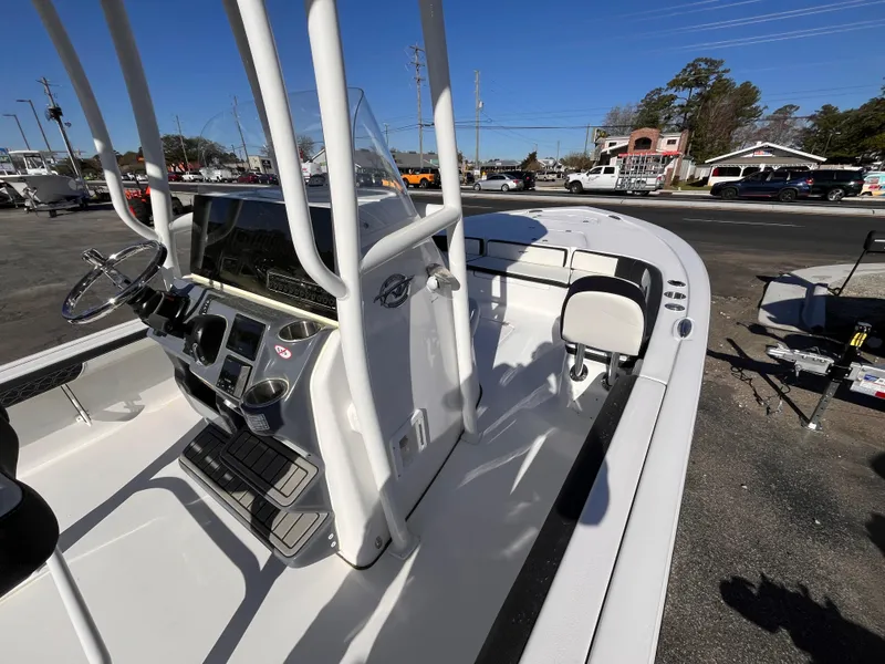 Slide: The Image of 2025 Tidewater 2300 Carolina Bay boat interior with steering console and seating. - 9