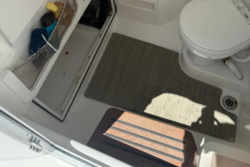 Slide: The Image of Interior of 2019 Everglades 273 Center Console boat with toilet and storage area. - 11
