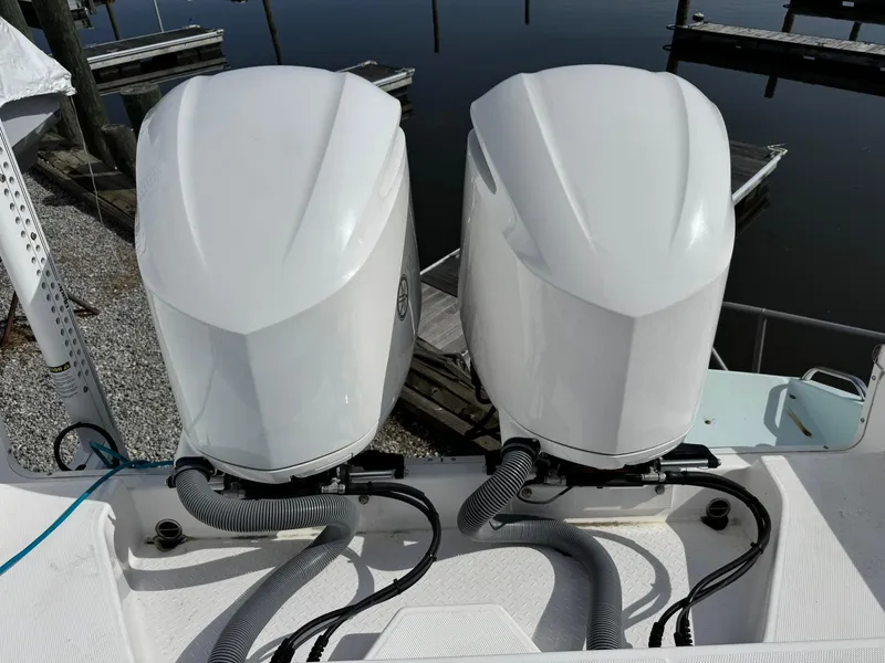 Slide: The Image of Twin outboard engines on a 2019 Everglades 273 CC boat at a dock. - 12
