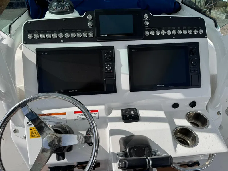 Slide: The Image of Control panel of 2019 Everglades 273 CC boat with Garmin displays and steering wheel. - 19