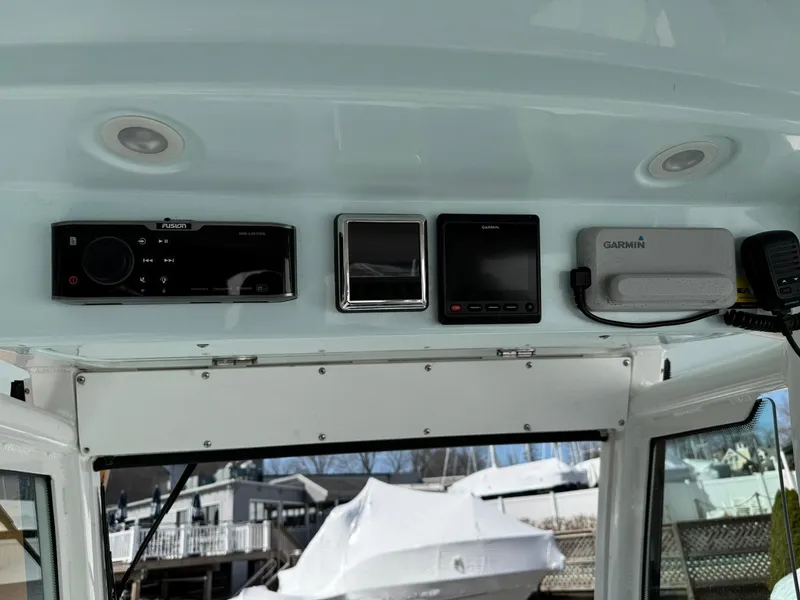 Slide: The Image of 2019 Everglades 273 CC boat dashboard with electronic controls and navigation equipment. - 23