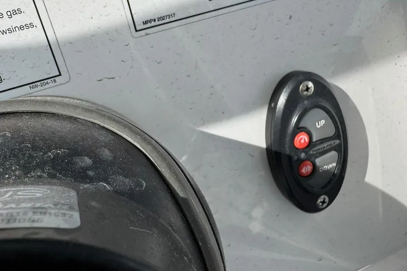 Slide: The Image of Control panel of 2019 Everglades 273 CC boat with up and down buttons. - 28
