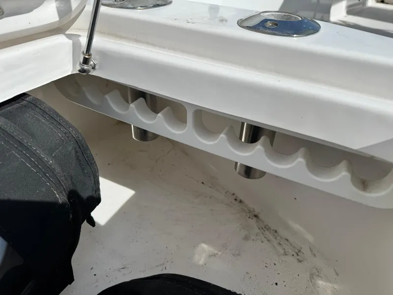Slide: The Image of Interior view of 2019 Everglades 273 CC boat, featuring rod holders and storage compartments. - 31
