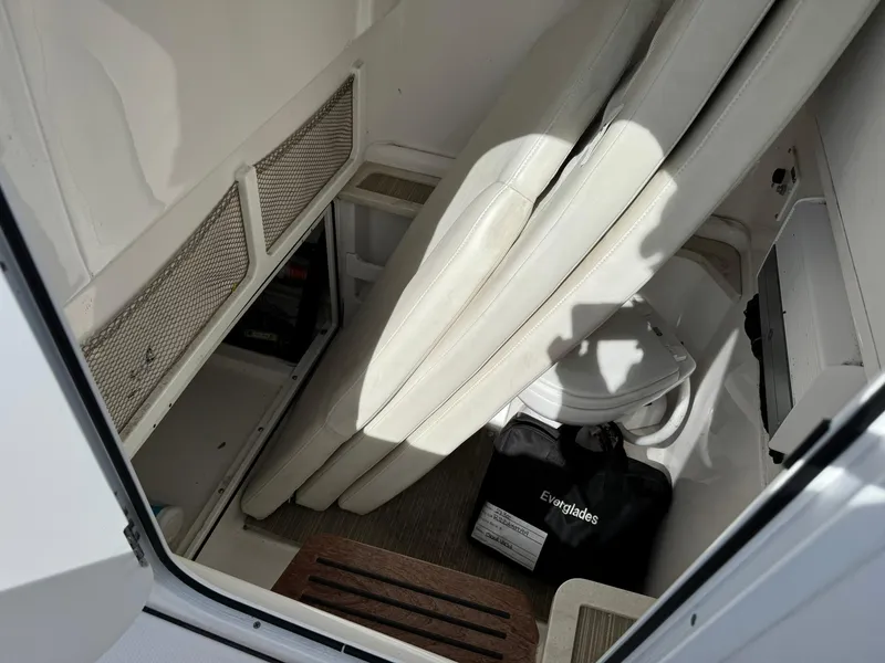 Slide: The Image of 2019 Everglades 273 CC boat interior with seating and storage area. - 34