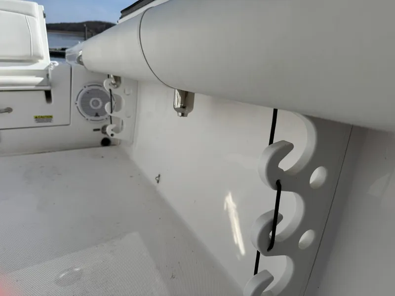 Slide: The Image of 2019 Everglades 273 CC boat interior with rod holders and speaker. - 36