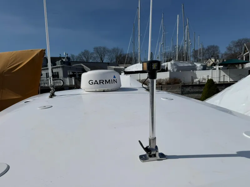 Slide: The Image of 2019 Everglades 273 CC boat with Garmin equipment on deck, docked near other boats. - 38