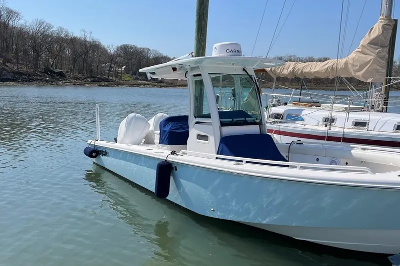 Slide: The Image of 2019 Everglades 273 Center Console boat docked on calm water. - 4