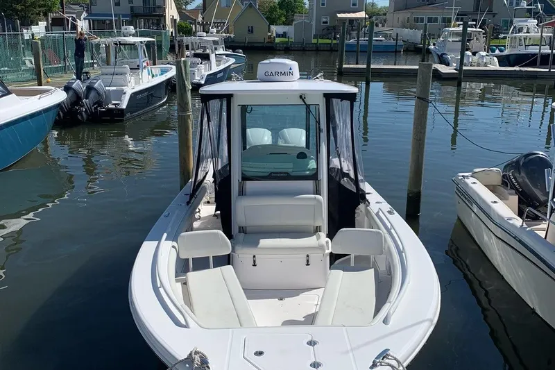 Slide: The Image of 2019 Everglades 273 Center Console boat docked in a marina. - 6