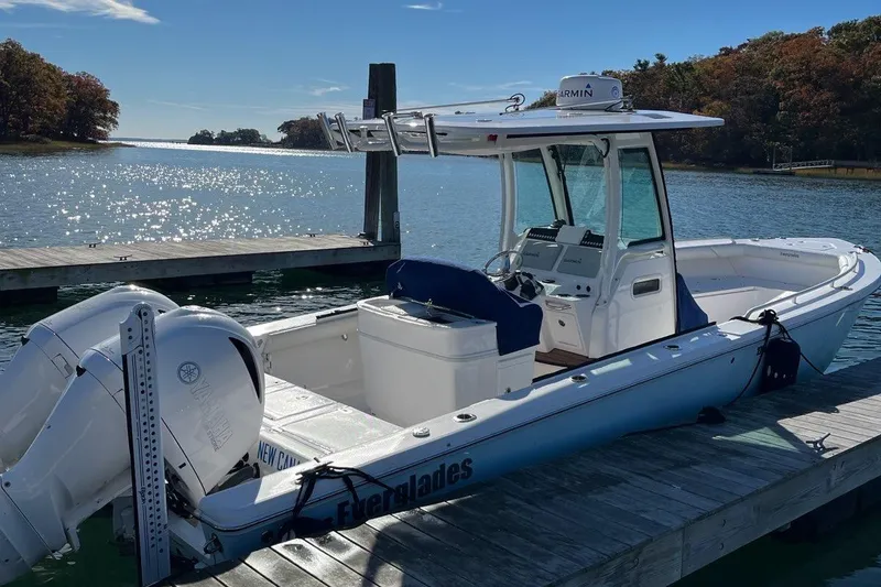 Slide: The Image of 2019 Everglades 273 Center Console boat docked by scenic waterfront. - 7