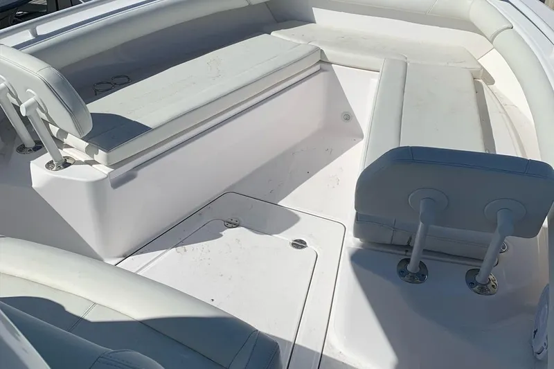 Slide: The Image of 2019 Everglades 273 Center Console boat interior with white seating and storage. - 9