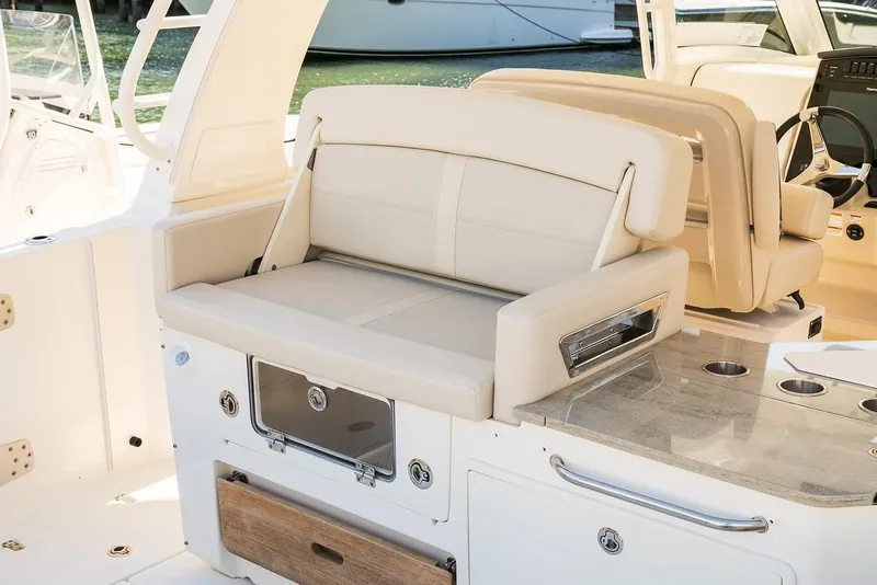 Slide: The Image of 2019 Boston Whaler 350 Realm interior with beige seating and sleek design. - 14
