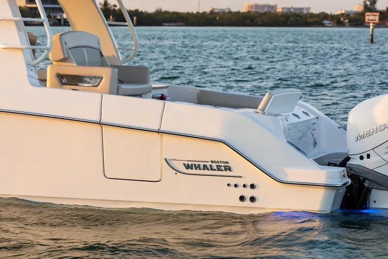 Slide: The Image of 2019 Boston Whaler 350 Realm boat on water, featuring sleek design and powerful engine. - 16