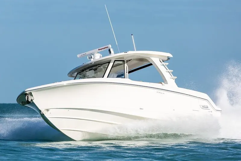 Slide: The Image of 2019 Boston Whaler 350 Realm cruising on open water, showcasing sleek design and performance. - 2