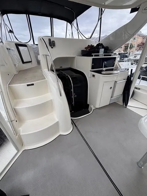 Slide: The Image of 2007 Meridian 459 Motoryacht interior with stairs, kitchenette, and seating area. - 10